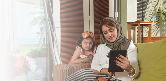 mother and young daughter using tablet device